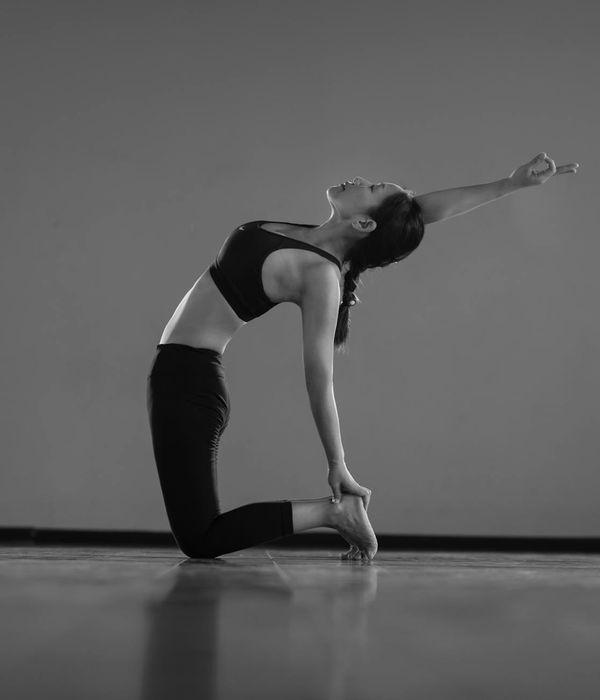Woman in a graceful yoga flow pose, embodying calm and strength.